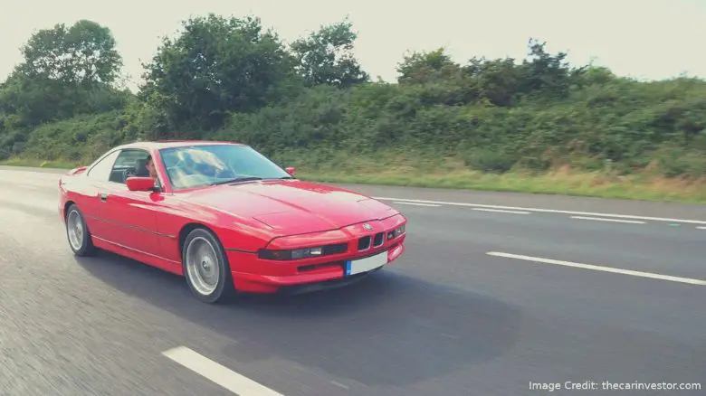 A red BMW 840 on the road