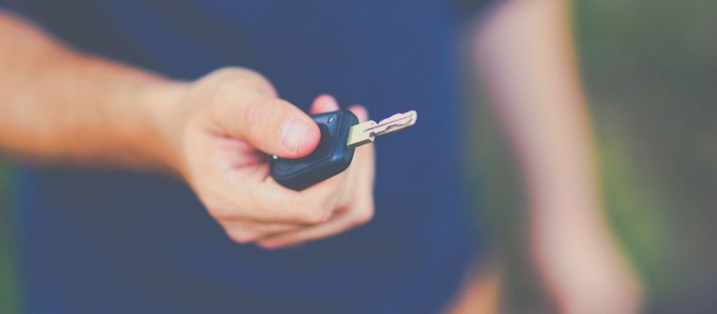 A man holding a car key