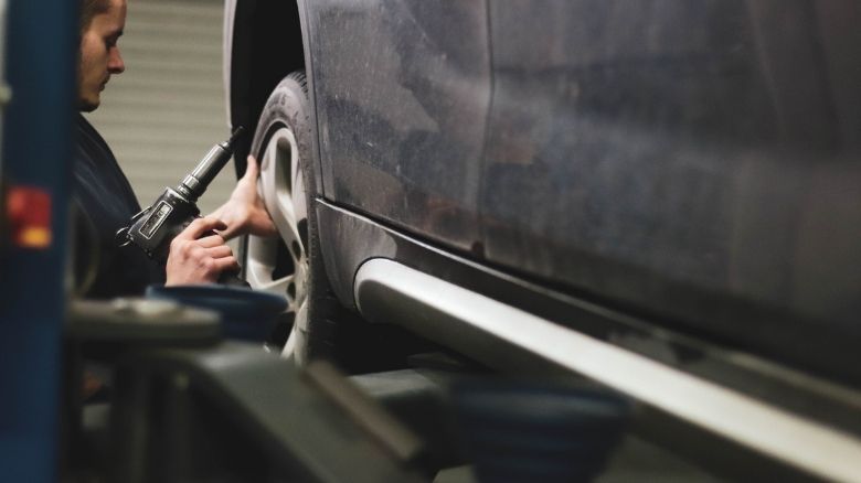 A mechanic servicing a car