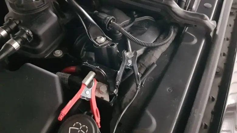 A trickle charger connected to a BMW M5