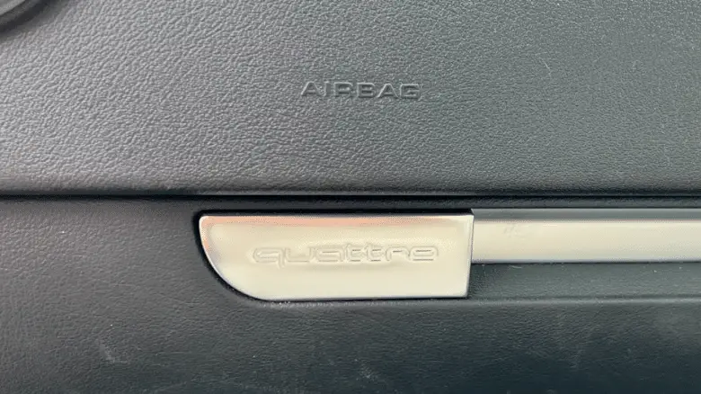Audi quattro badge on the glove box