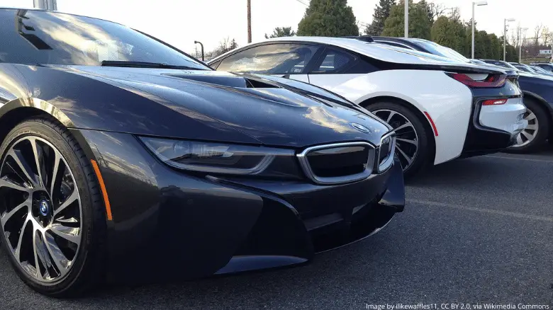 A black BMW i8, and a white BMW i8