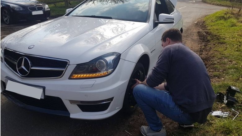 Mercedes C63 AMG with a puncture
